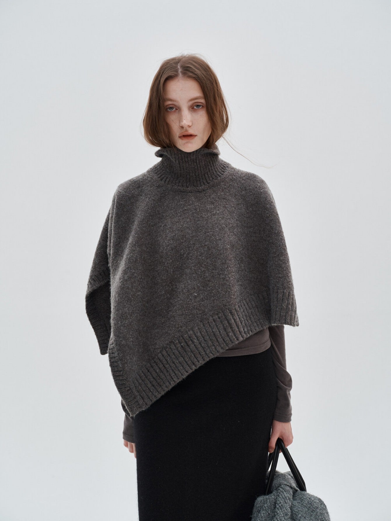 Eliraya unique asymmetrical knit cape for women, a winter cardigan shawl that adds warmth and an elegant touch to any outfit.