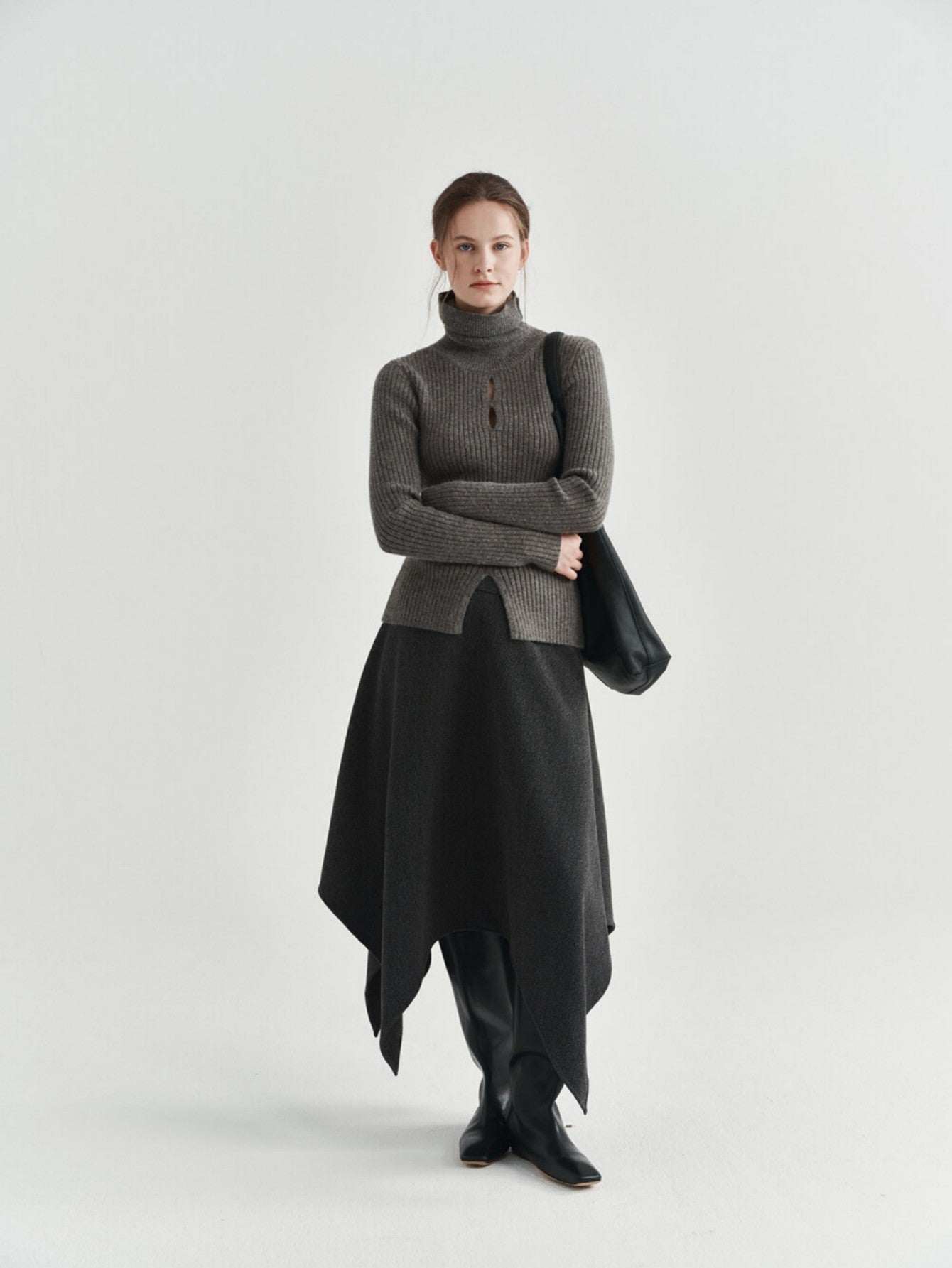 Eliraya asymmetrical wool skirt for women, featuring a thick wool design and uneven hem for a stylish winter midi skirt.