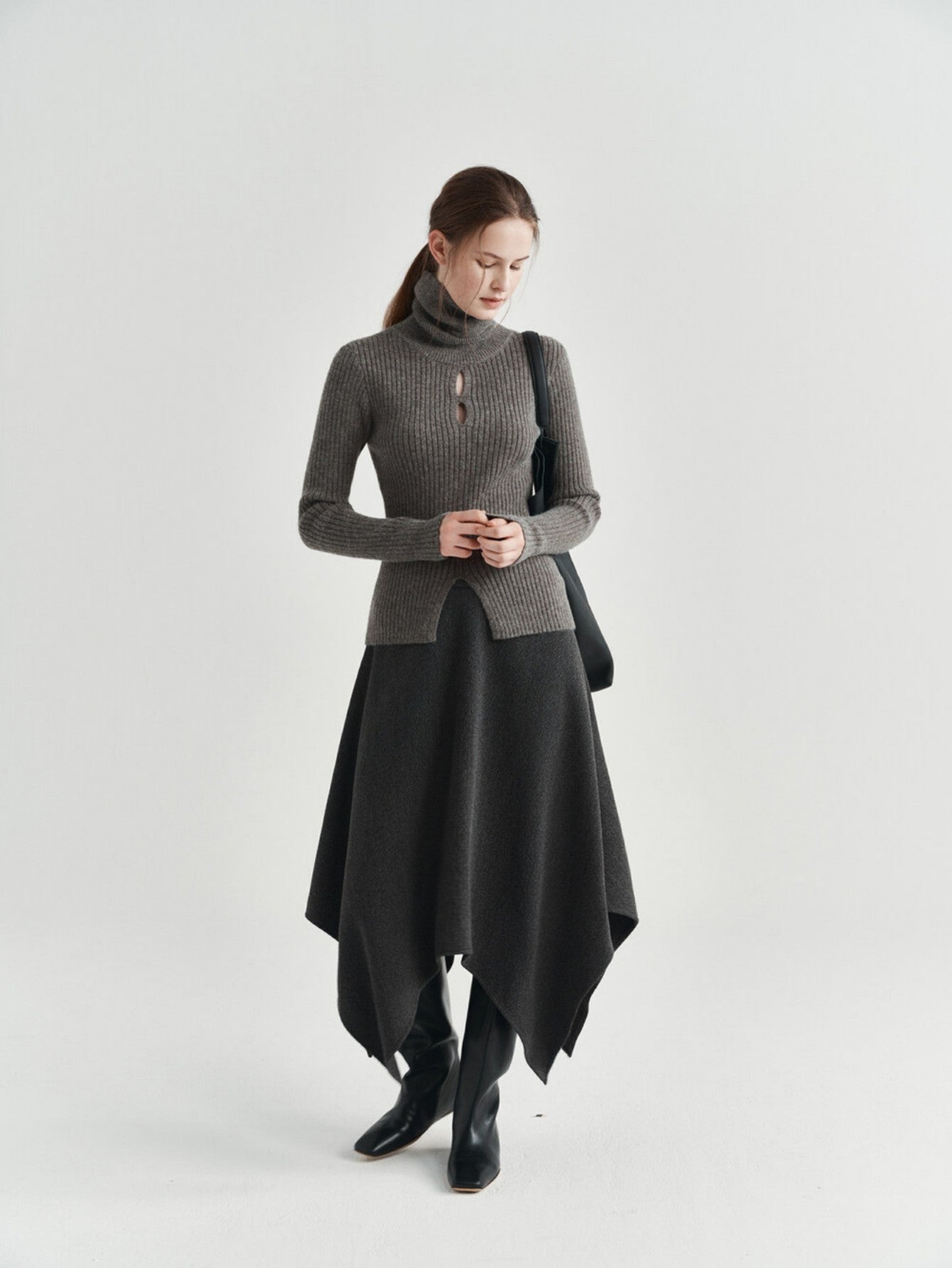 Eliraya asymmetrical wool skirt for women, featuring a thick wool design and uneven hem for a stylish winter midi skirt.