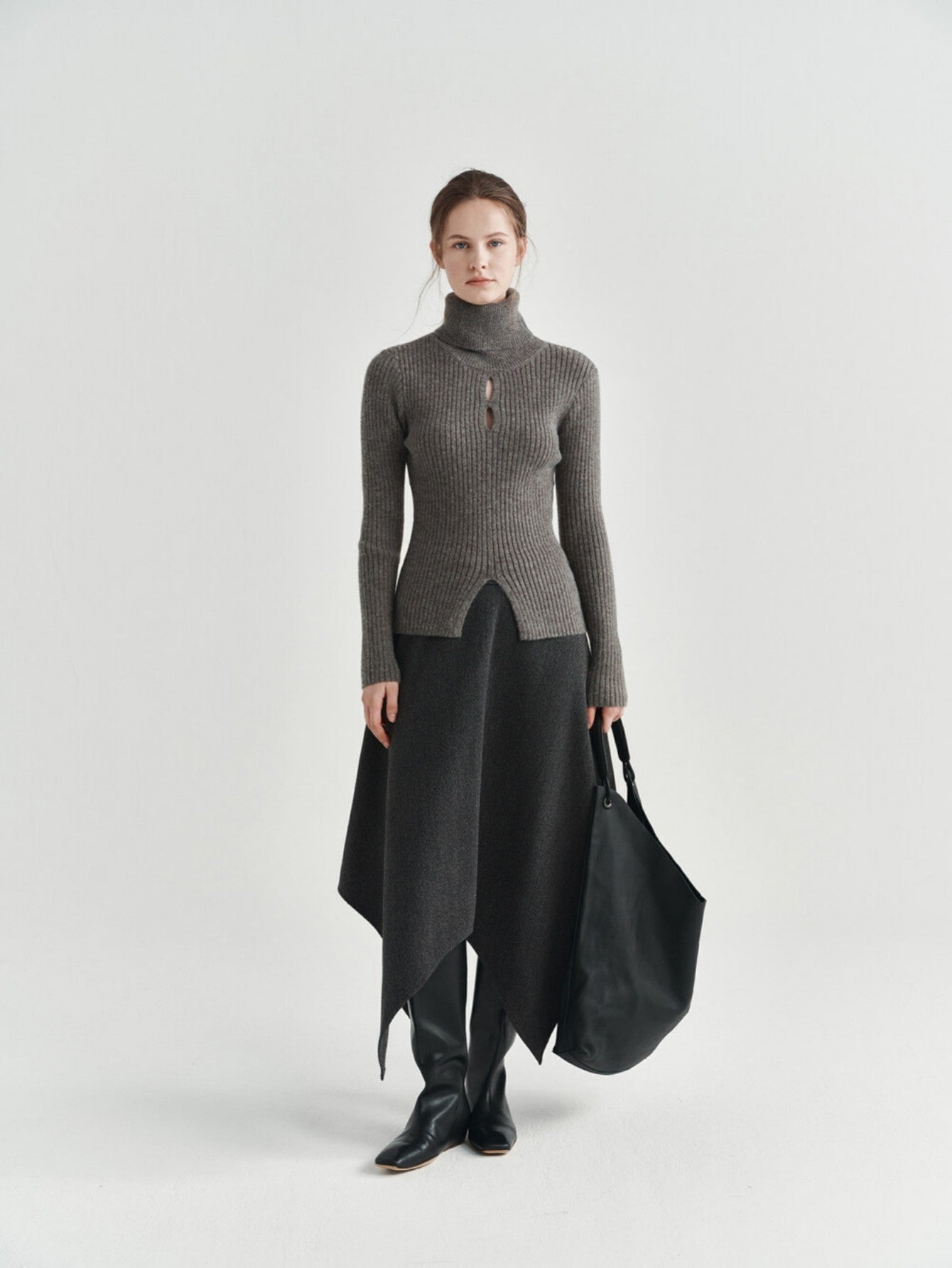 Eliraya asymmetrical wool skirt for women, featuring a thick wool design and uneven hem for a stylish winter midi skirt.