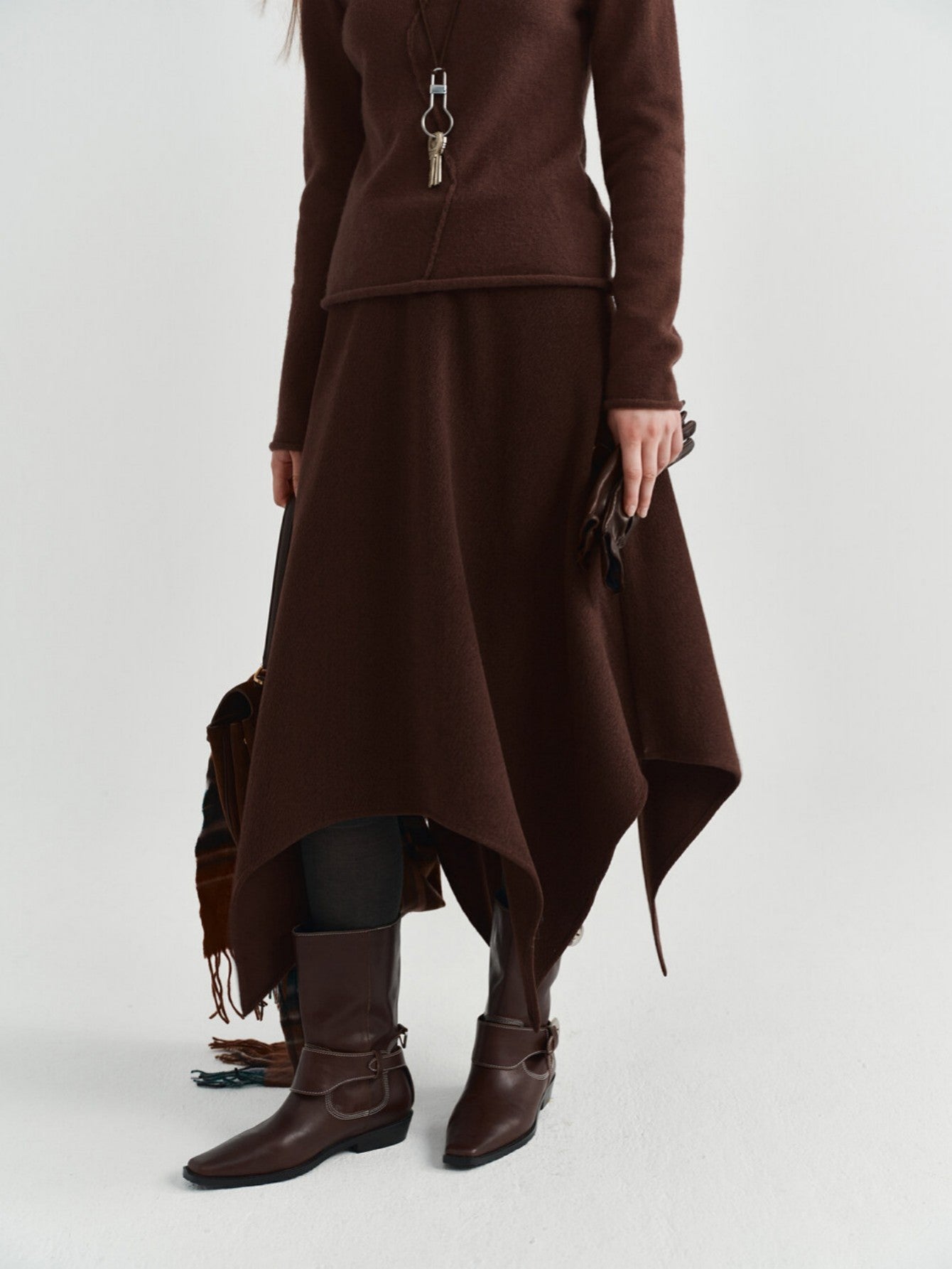 Eliraya asymmetrical wool skirt for women, featuring a thick wool design and uneven hem for a stylish winter midi skirt.