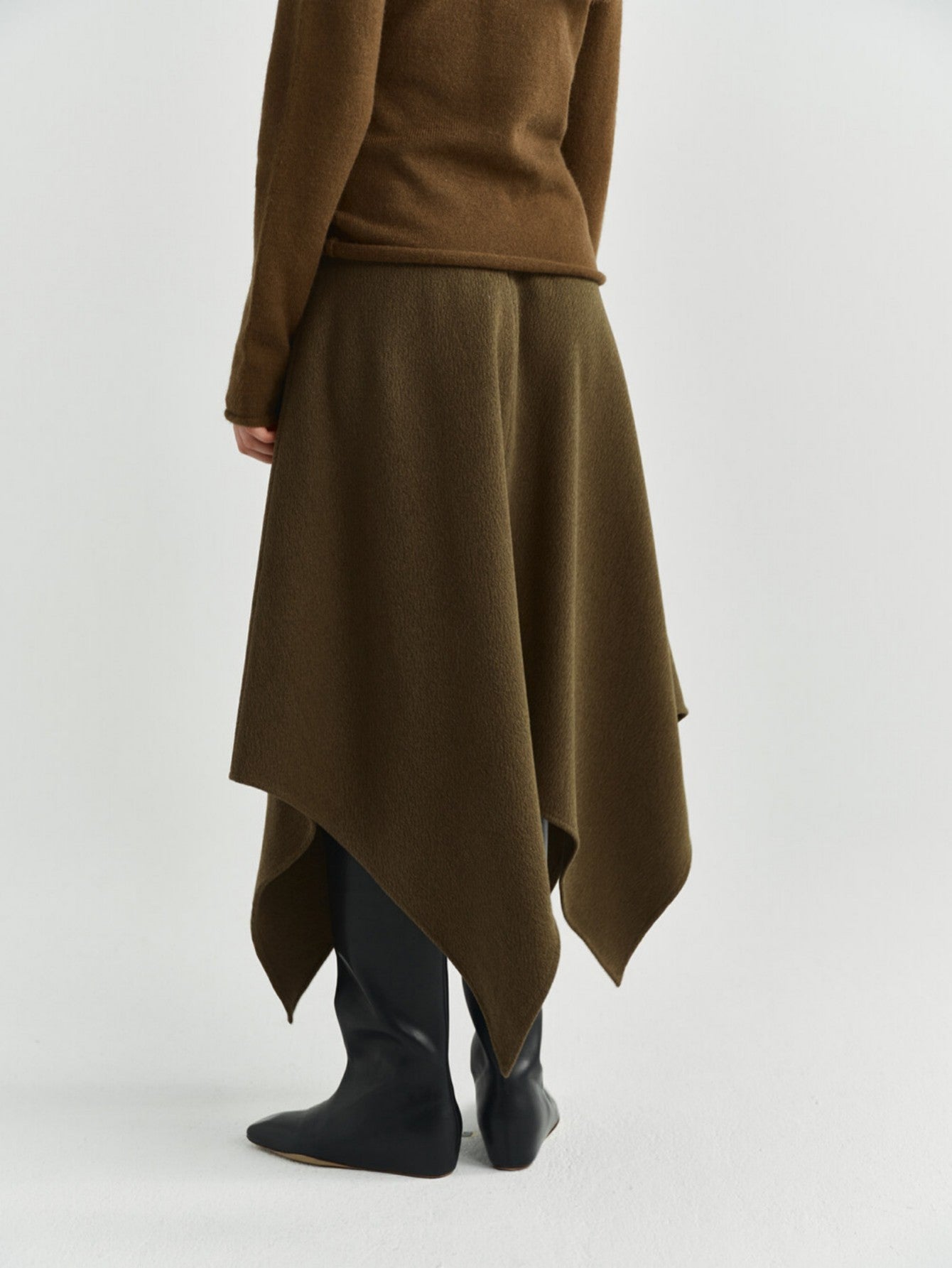 Eliraya asymmetrical wool skirt for women, featuring a thick wool design and uneven hem for a stylish winter midi skirt.