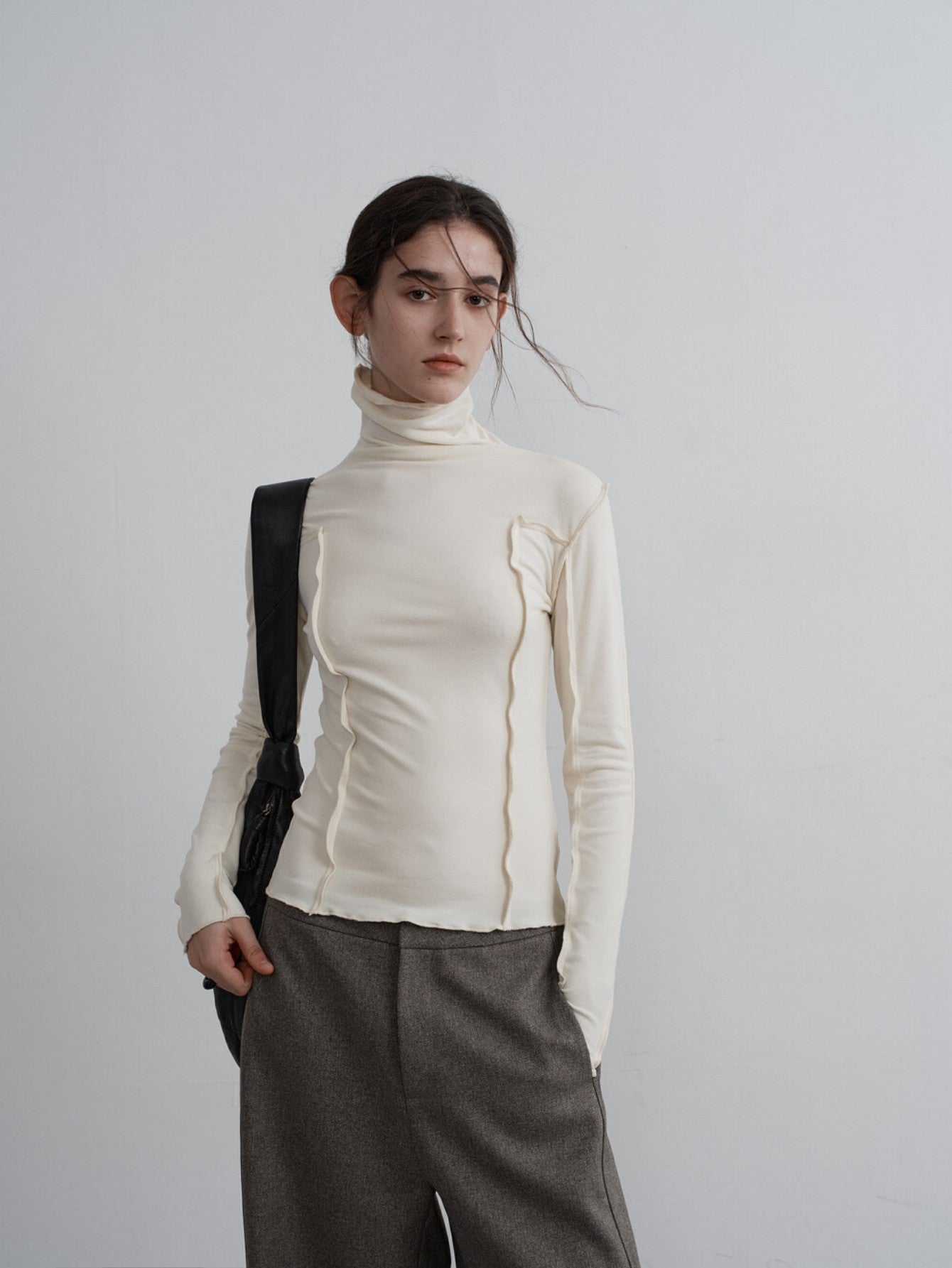 Eliraya slim-fit cowl neck knit top for women, featuring ruffle details and a layered design, ideal for winter layering and styling.