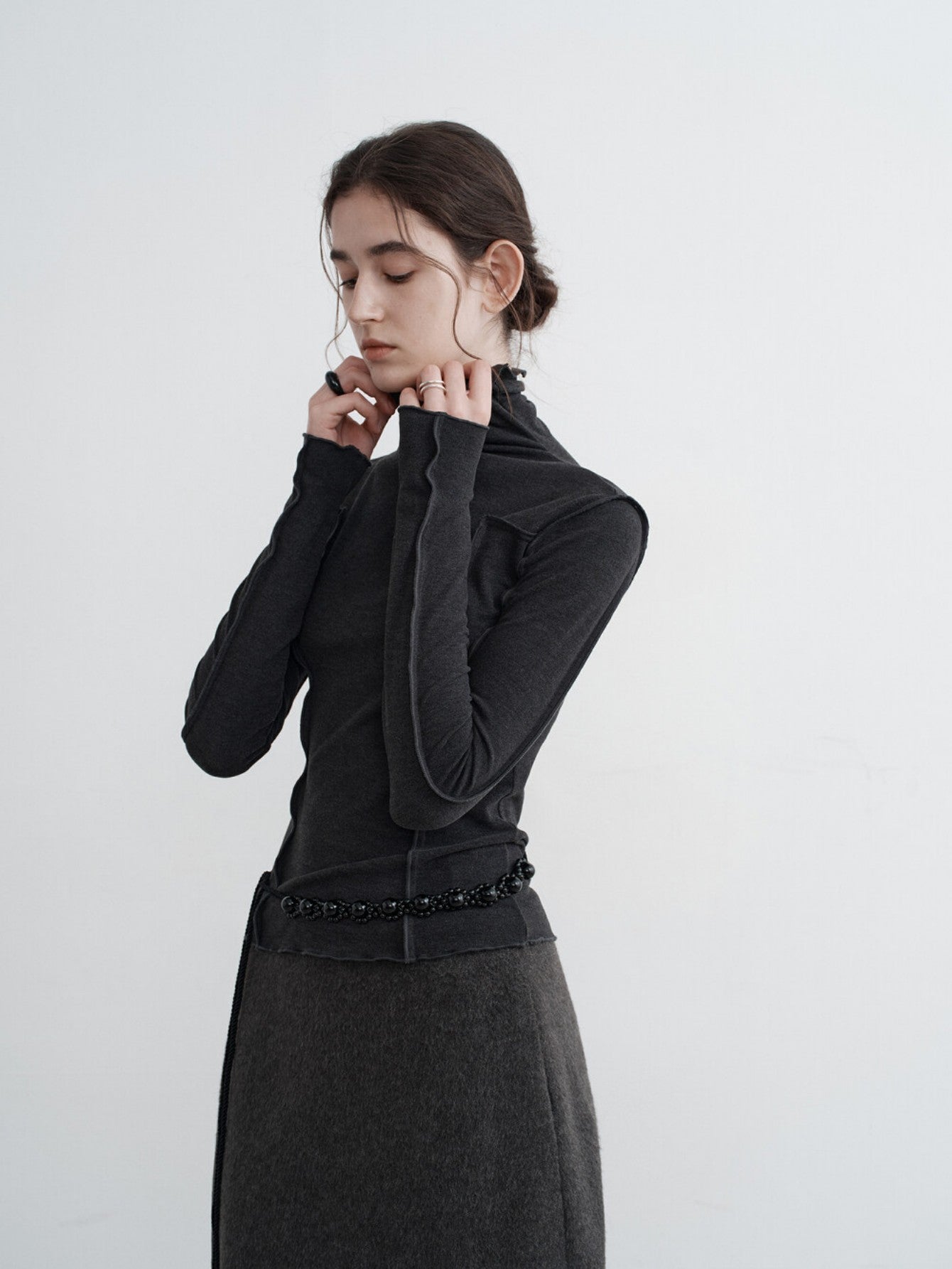 Eliraya slim-fit cowl neck knit top for women, featuring ruffle details and a layered design, ideal for winter layering and styling.