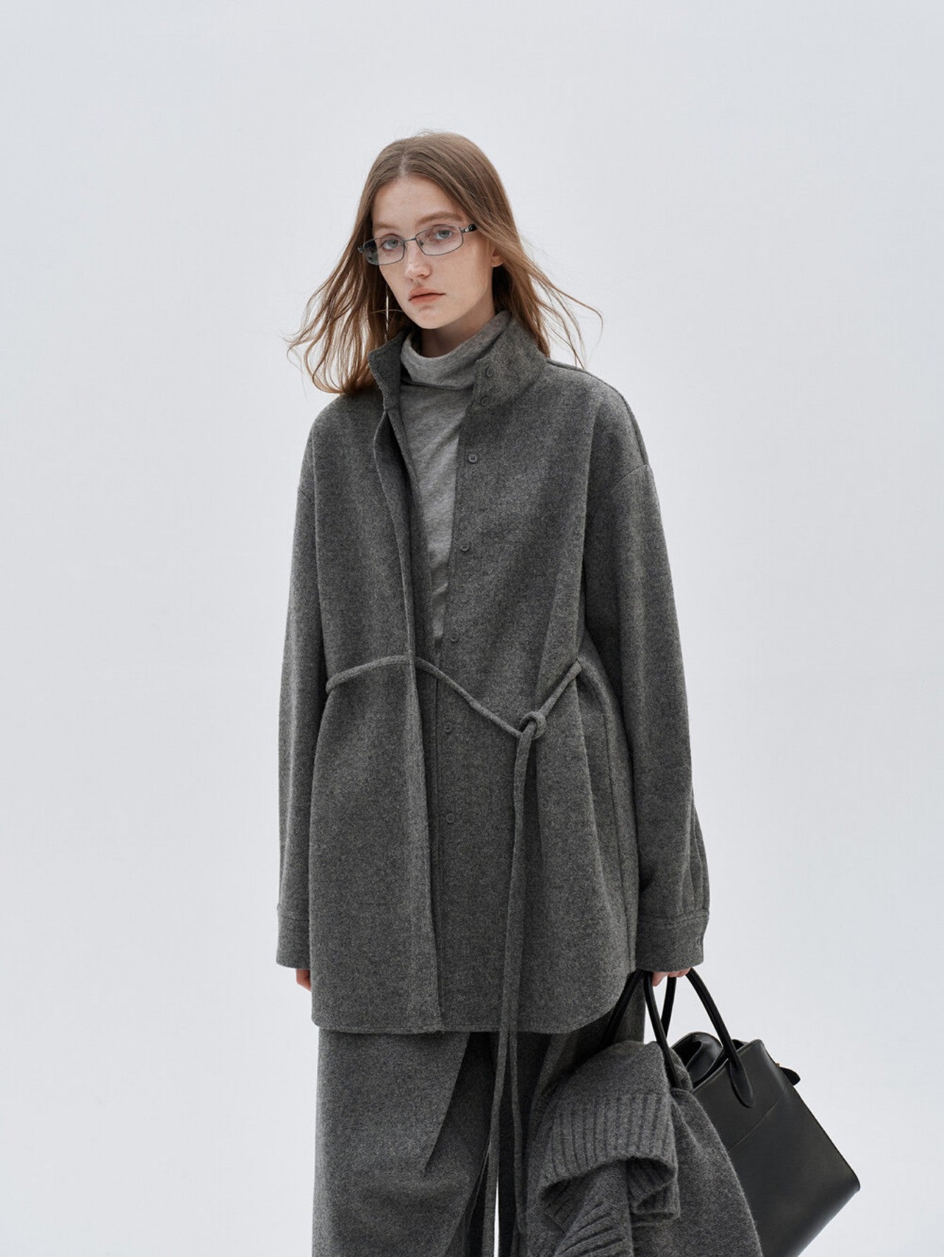 Eliraya French wool overcoat for women, featuring a high-neck and belted design for a warm, sophisticated winter look.