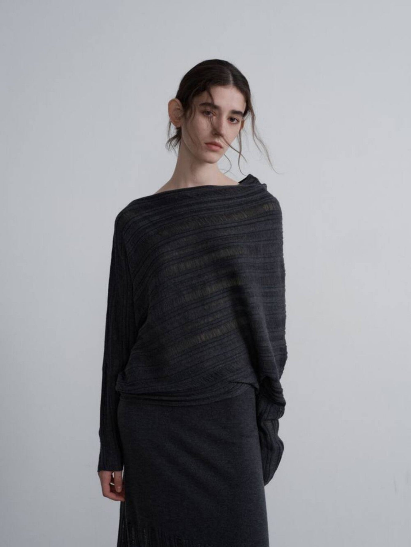 Eliraya off-shoulder knit sweater for women, featuring a relaxed fit and asymmetrical cut-out design for a stylish and warm winter look.