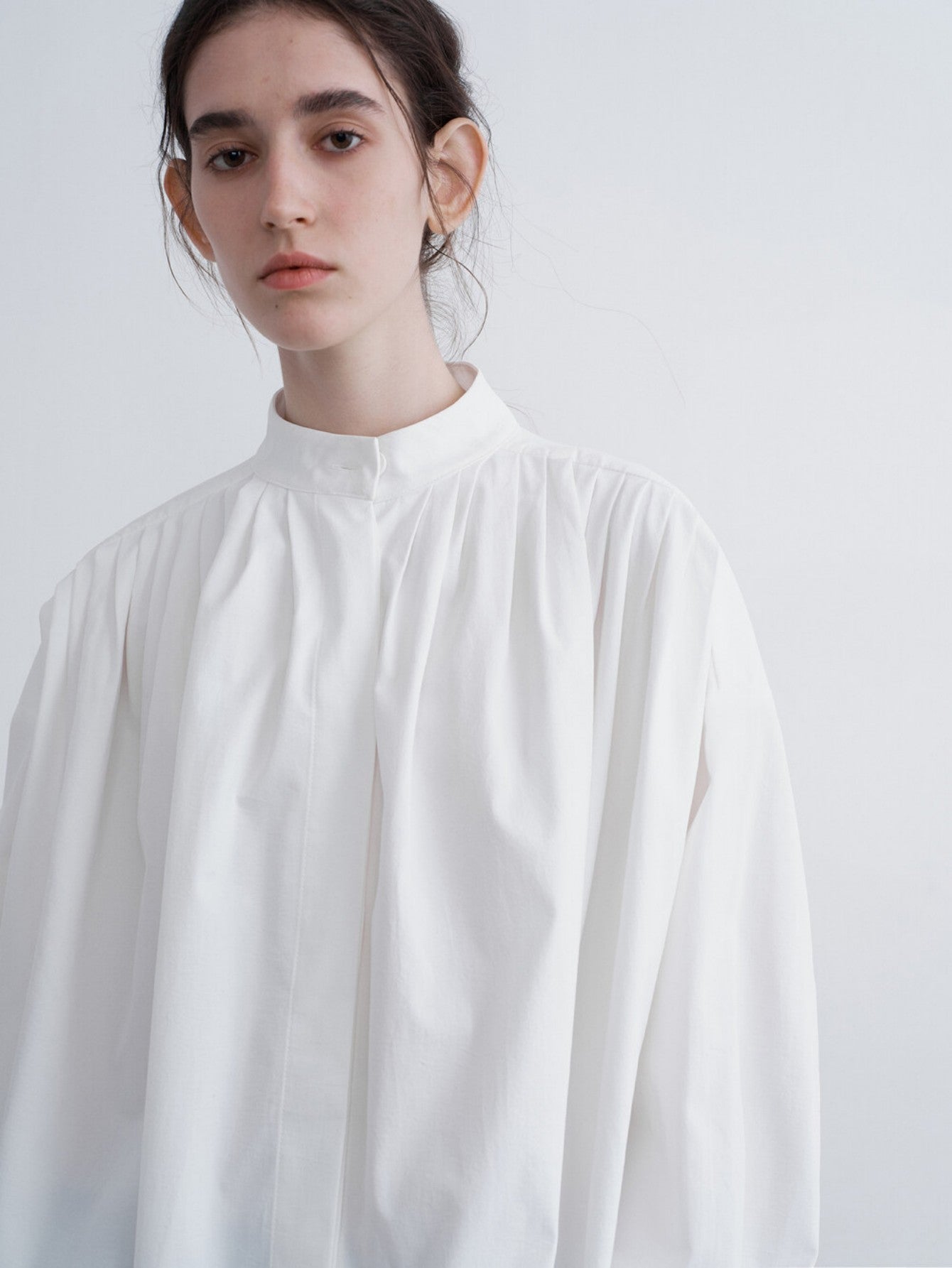 Eliraya pleated white blouse for women, featuring a draped collar and loose fit for an elegant French-style autumn look.