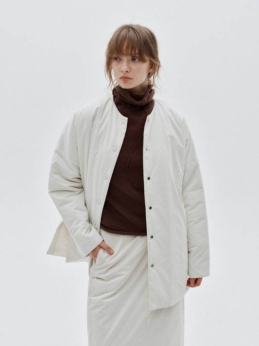 Eliraya white split-hem puffer jacket for women, designed for warmth and style with thick padding and a modern look for winter.