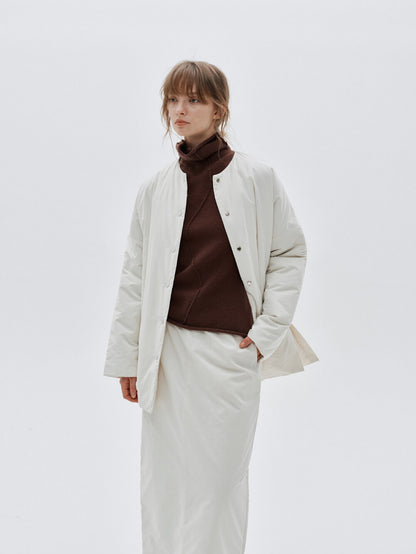 Eliraya white split-hem puffer jacket for women, designed for warmth and style with thick padding and a modern look for winter.