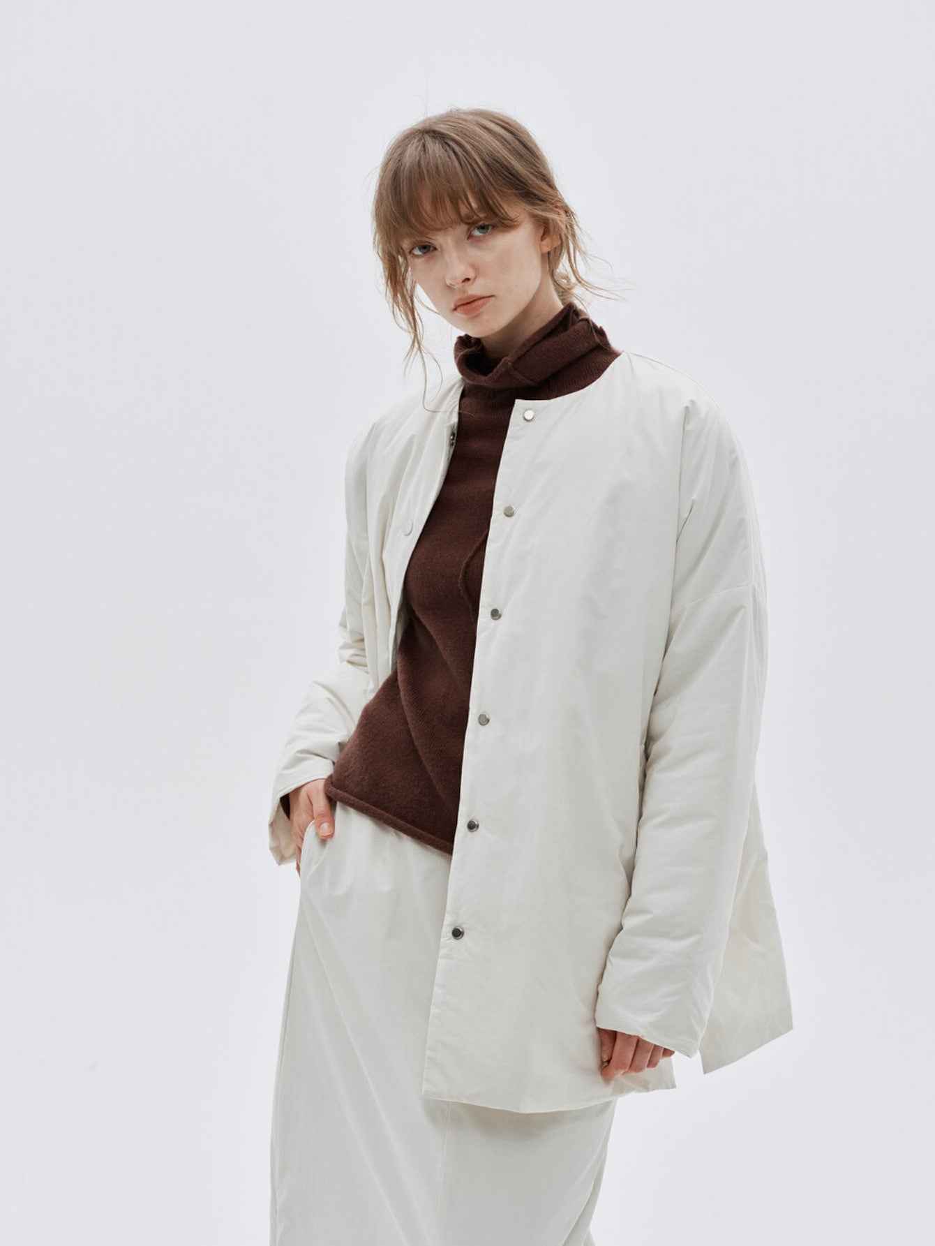 Eliraya white split-hem puffer jacket for women, designed for warmth and style with thick padding and a modern look for winter.