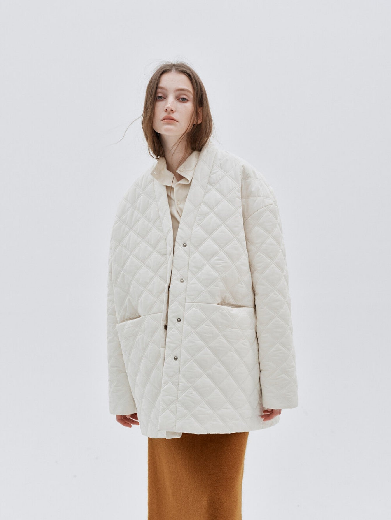 Eliraya white checkered cotton coat for women, featuring a V-neck and oversized fit, designed for winter warmth and French-inspired style.