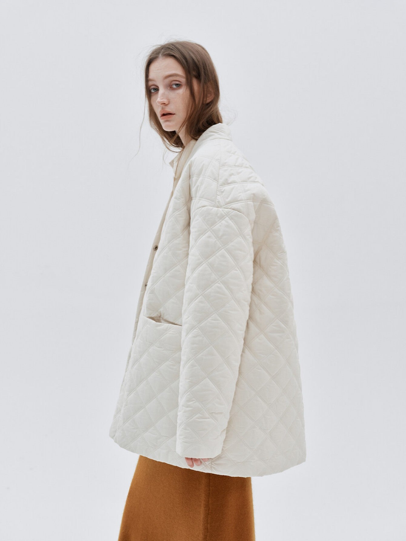 Eliraya white checkered cotton coat for women, featuring a V-neck and oversized fit, designed for winter warmth and French-inspired style.