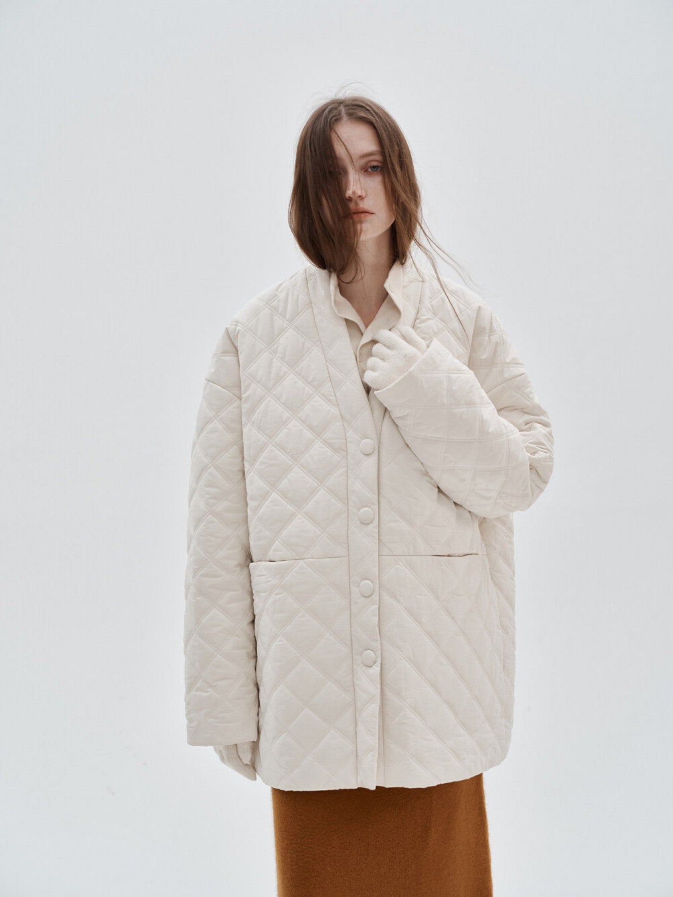 Eliraya white checkered cotton coat for women, featuring a V-neck and oversized fit, designed for winter warmth and French-inspired style.