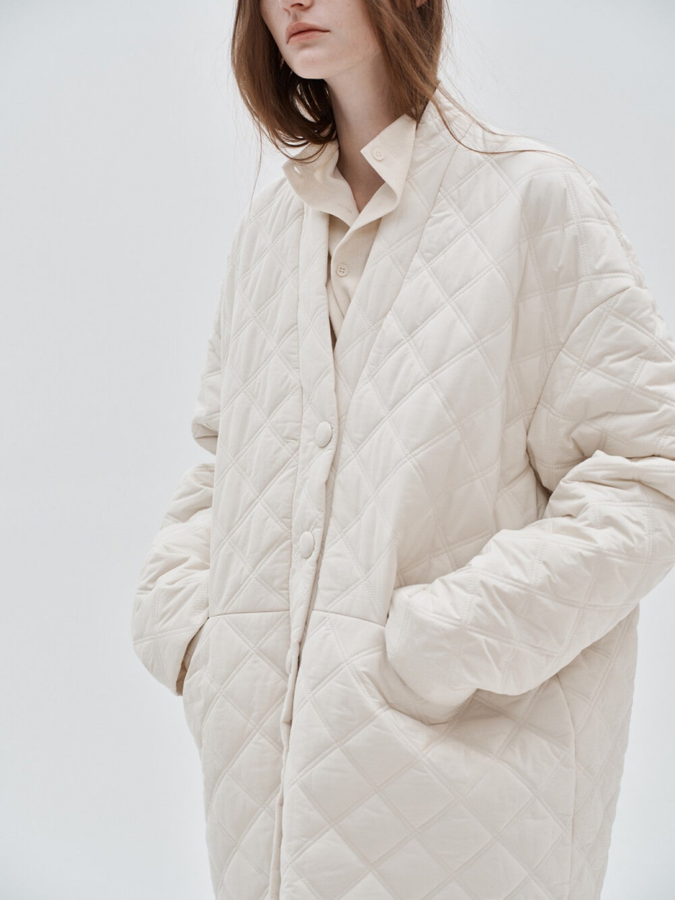 Eliraya white checkered cotton coat for women, featuring a V-neck and oversized fit, designed for winter warmth and French-inspired style.